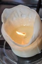 Burning white candle, melted wax, close up flame Royalty Free Stock Photo