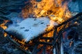 Burning wood, flame and smoke on blue background Royalty Free Stock Photo