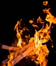 Burning wood, flames in the night with sparks Royalty Free Stock Photo