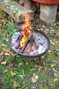Burning wood in a rusty fire bowl Royalty Free Stock Photo