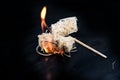 Burning wood wool barbecue lighter on a black metal bowl, copy s Royalty Free Stock Photo