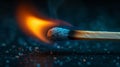 A close-up of a burning wooden match on black background.