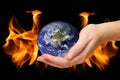 Burning world earth. Global catasrtophe concept. This image elements furnished by NASA. Apocalypse. Planet Earth in hand Royalty Free Stock Photo