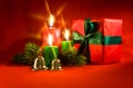 Burning xmas candle and little gift box Royalty Free Stock Photo