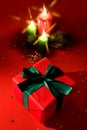 Burning xmas candle and little gift box Royalty Free Stock Photo