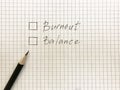 burnout or balance chechboxex on checkered sheet of paper. Black pencil near to choose. Burnout at work concept Royalty Free Stock Photo