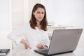 Burnout : tired businesswoman frowning at laptop - back pains or