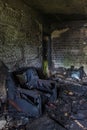 Burnt apartment house interior. Burned chair, charred walls