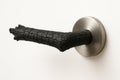A burnt branch in the form of a doorknob. Royalty Free Stock Photo