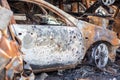 Burnt car body riddled with bullets. Russia`s war against Ukraine. Shot by the Russian military car of civilians during the