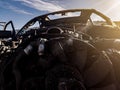 A burnt car engine with propeller after a fire or an accident in a parking lot covered with rust and black coal with scattered