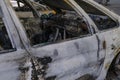 Burnt car`s door in the street close-up. Riot, civil protest, hooliganism, criminal in the city. Explosion, fire result. Car insur