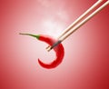 Burnt Chopsticks in Smoke While Pinching Hot Chilli Pepper Royalty Free Stock Photo
