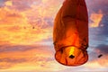 Burnt damaged sky lantern with kites in background