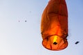 Burnt damaged sky lantern with kites in background