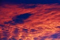 Burnt dark dramatic hurricane clouds in the sky in windy weather after sunset. Background with copy space Royalty Free Stock Photo