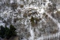 Burnt destroyed house in a winter snowy park, top view