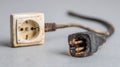 Burnt Electrical Socket and Damaged Plug From Short Circuit in Home Setting During Daylight Royalty Free Stock Photo