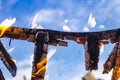 Burnt fence close-up on the ashes of a large fire, on a blurred background with a bokeh effect Royalty Free Stock Photo