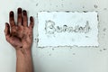 A burnt hand and white paper with burnout word. Work life balance, work stress and burnout concept Royalty Free Stock Photo