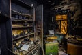 Burnt house interior. Burned kitchen, furniture, door, charred walls and ceiling in black soot