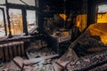 Burnt house interior. Burned kitchen, remains of stove and furniture in black soot Royalty Free Stock Photo