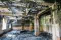 Burnt house interior. Burned room with columns, charred walls and ceiling in black soot Royalty Free Stock Photo