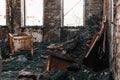 Burnt house interior. Burned room in industrial building, charred furniture and damaged apartment after fire Royalty Free Stock Photo