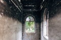 Burnt mansion interior. Broken windows, walls in black soot