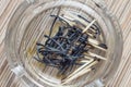 Burnt matches in a glass ashtray on wooden background texture