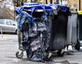 Burnt and melted trash can form a fire.