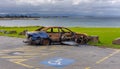 Burnt out abandoned car at stormy beach Royalty Free Stock Photo