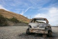 Burnt out car on the side of a road Royalty Free Stock Photo