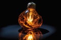 burnt-out lightbulb with a glowing filament reflection