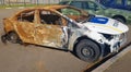 Burnt out police car. Vandalism, burned car. Car after the fire. Auto trash. Destroyed patrol car of the Ukrainian national police Royalty Free Stock Photo