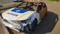 Burnt out police car. Vandalism, burned car. Car after the fire. Auto trash. Destroyed patrol car of the Ukrainian national police