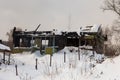 A burnt-out wooden house on the winter