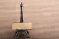 Burnt paper on model Eiffel tower on cardboard