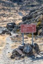 Burnt rocks at the Palisades Trail and sign