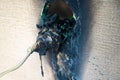 Burnt power outlet. Melted-off and burned plastic socket of power supply