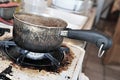 Burnt saucepan on dirty cooker Royalty Free Stock Photo