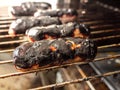 Burnt sausages on the grill Royalty Free Stock Photo