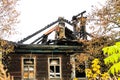 Burnt traditional Russian wooden house izba in autumn Royalty Free Stock Photo