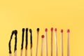 Burnt and whole matches on yellow background. Space for text