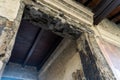 burnt wood from original doors and windows. Ancient city in Herculaneum archaeological park, Naples, Italy.