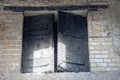 burnt wood from original doors and windows. Ancient city in Herculaneum archaeological park, Naples, Italy.