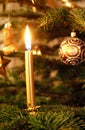 Burnung golden candle decorated Christmas tree