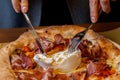 the burrata is broken open with a knife and fork and you can smell the wonderful aroma of the pizza Royalty Free Stock Photo