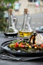 Burrata fresh italian cheese with Sauce pesto and vegetables. Bottles with sauce, gray tablecloth, spoon and fork. Opposite the Royalty Free Stock Photo