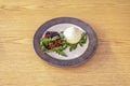 burrata with pepper, arugula, olives, tomato and basil on a blue and white plate Royalty Free Stock Photo